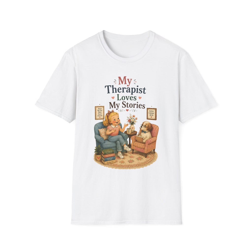 A white short-sleeve crewneck t-shirt featuring a cute cartoon graphic of a woman and her dog in a therapist's office, with the text 'My Therapist Loves My Stories'.