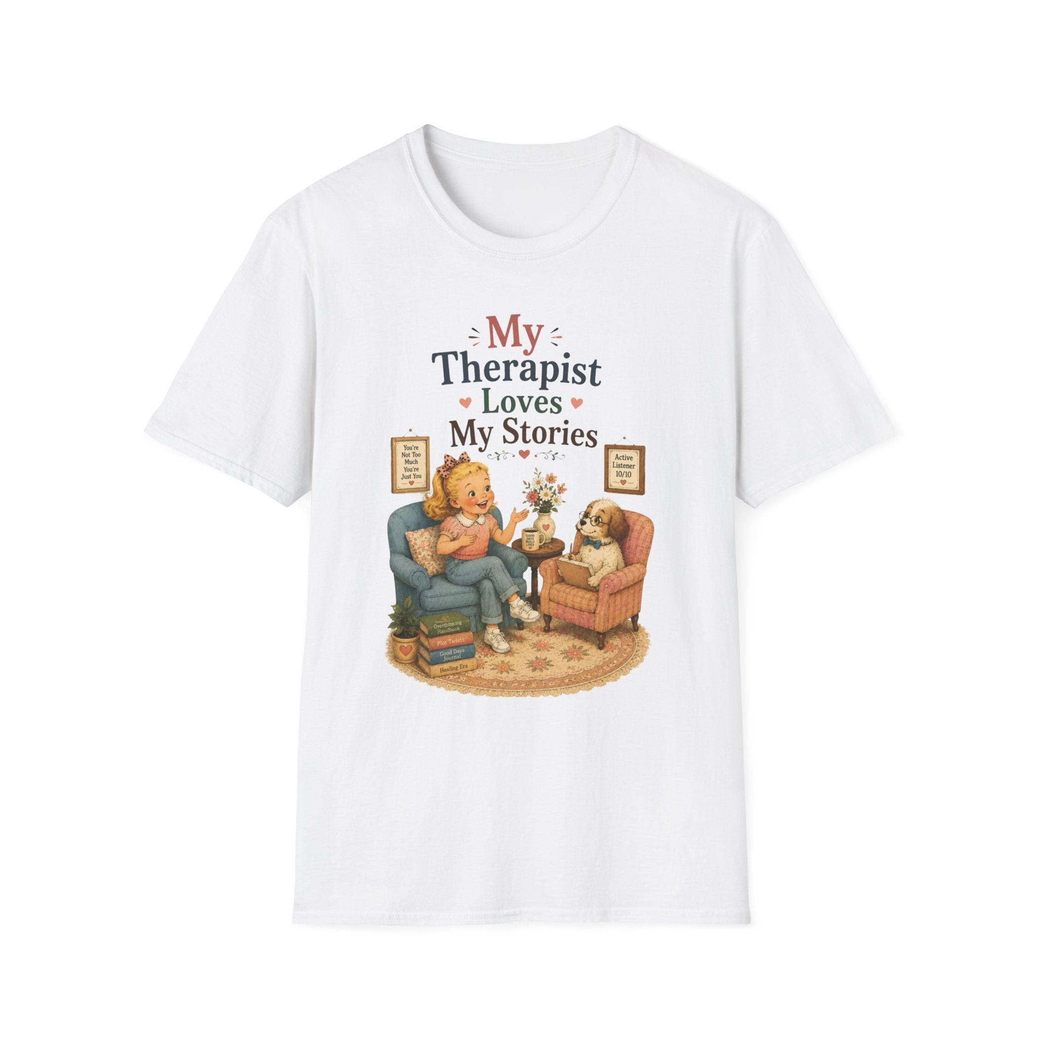 A white short-sleeve crewneck t-shirt featuring a cute cartoon graphic of a woman and her dog in a therapist's office, with the text 'My Therapist Loves My Stories'.