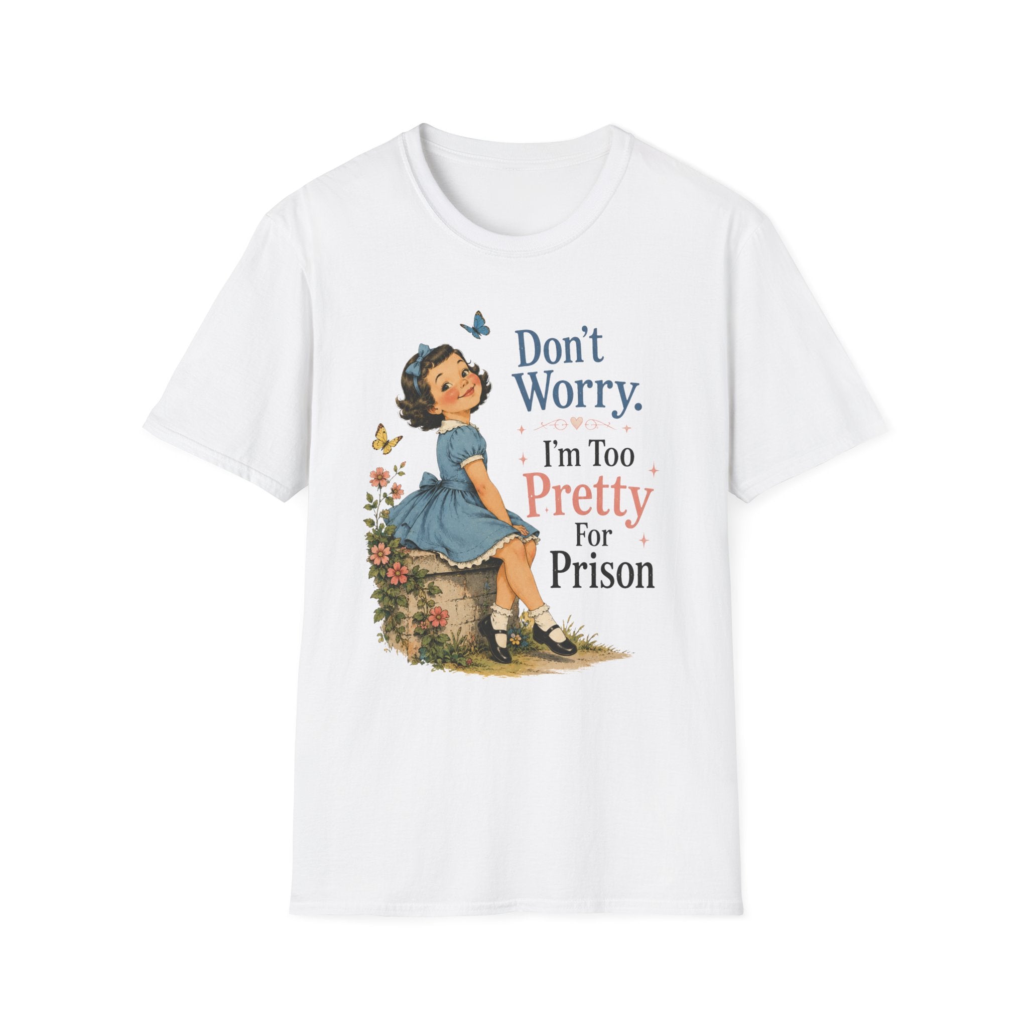 A white short-sleeve crewneck t-shirt featuring a vintage-style graphic of a young girl in a blue dress sitting on a stone, surrounded by flowers and butterflies, with the text 'Don't Worry. I'm Too Pretty For Prison' printed on the front.