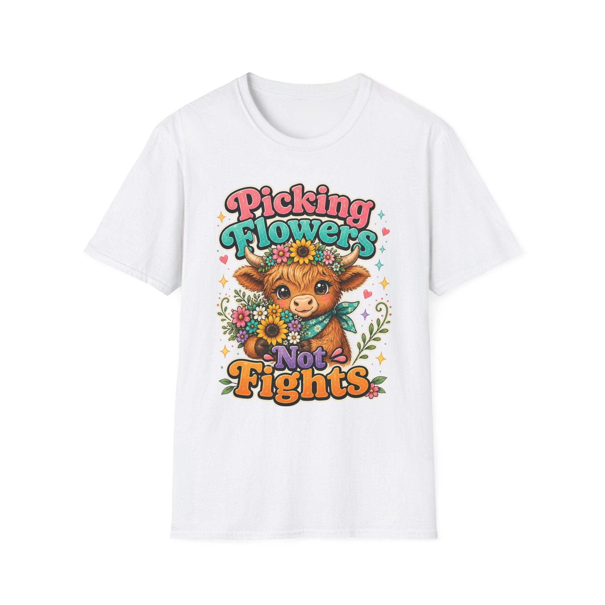 A white short-sleeve crewneck t-shirt featuring a colorful graphic print of a cartoon cow wearing a flower crown and holding sunflowers, surrounded by the text 'Picking Flowers Not Fights' in playful multicolor lettering.