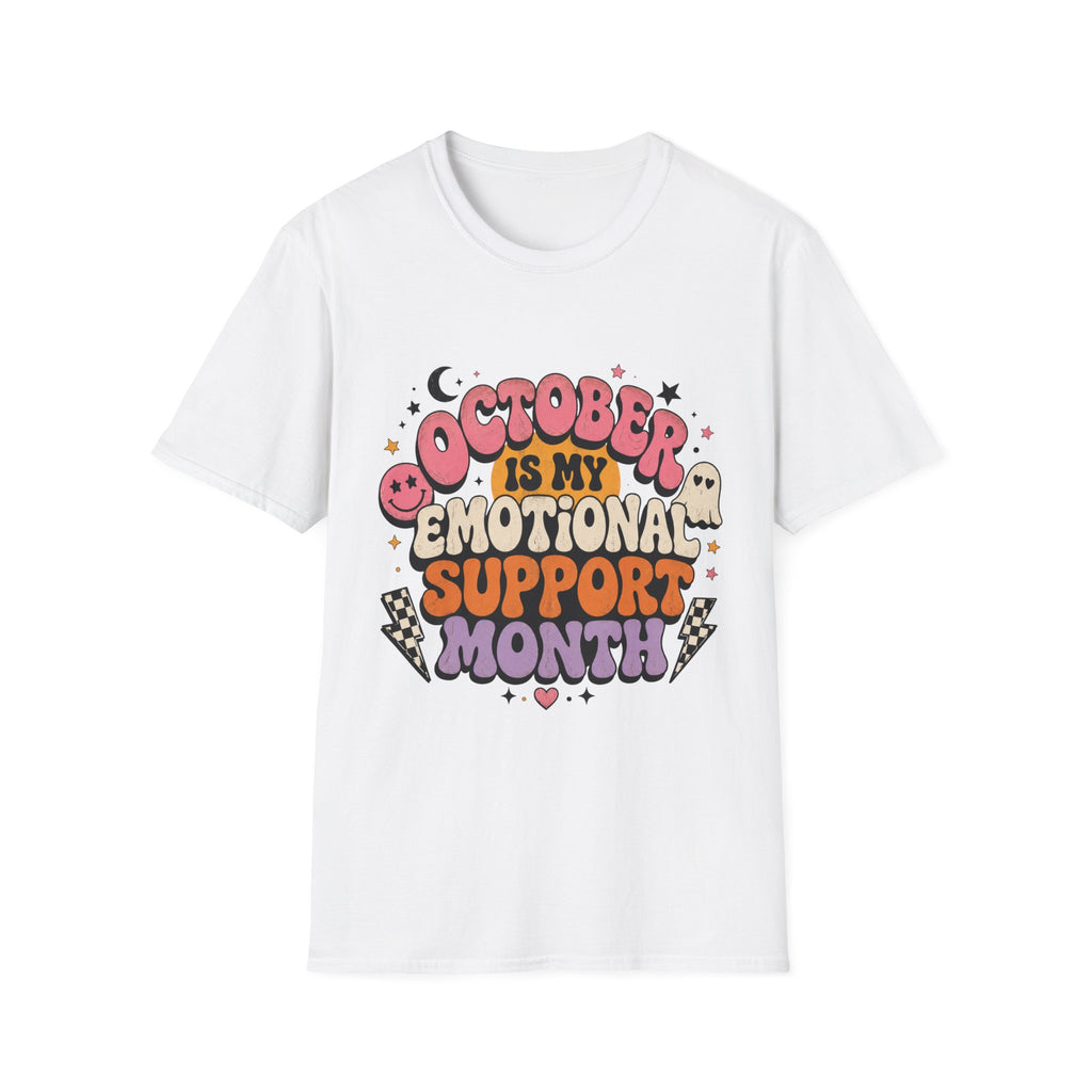 A white short-sleeve crewneck t-shirt featuring a colorful graphic on the front that reads 'OCTOBER IS MY EMOTIONAL SUPPORT MONTH' in playful, Halloween-themed lettering with cute illustrations of a ghost, moon, and stars.