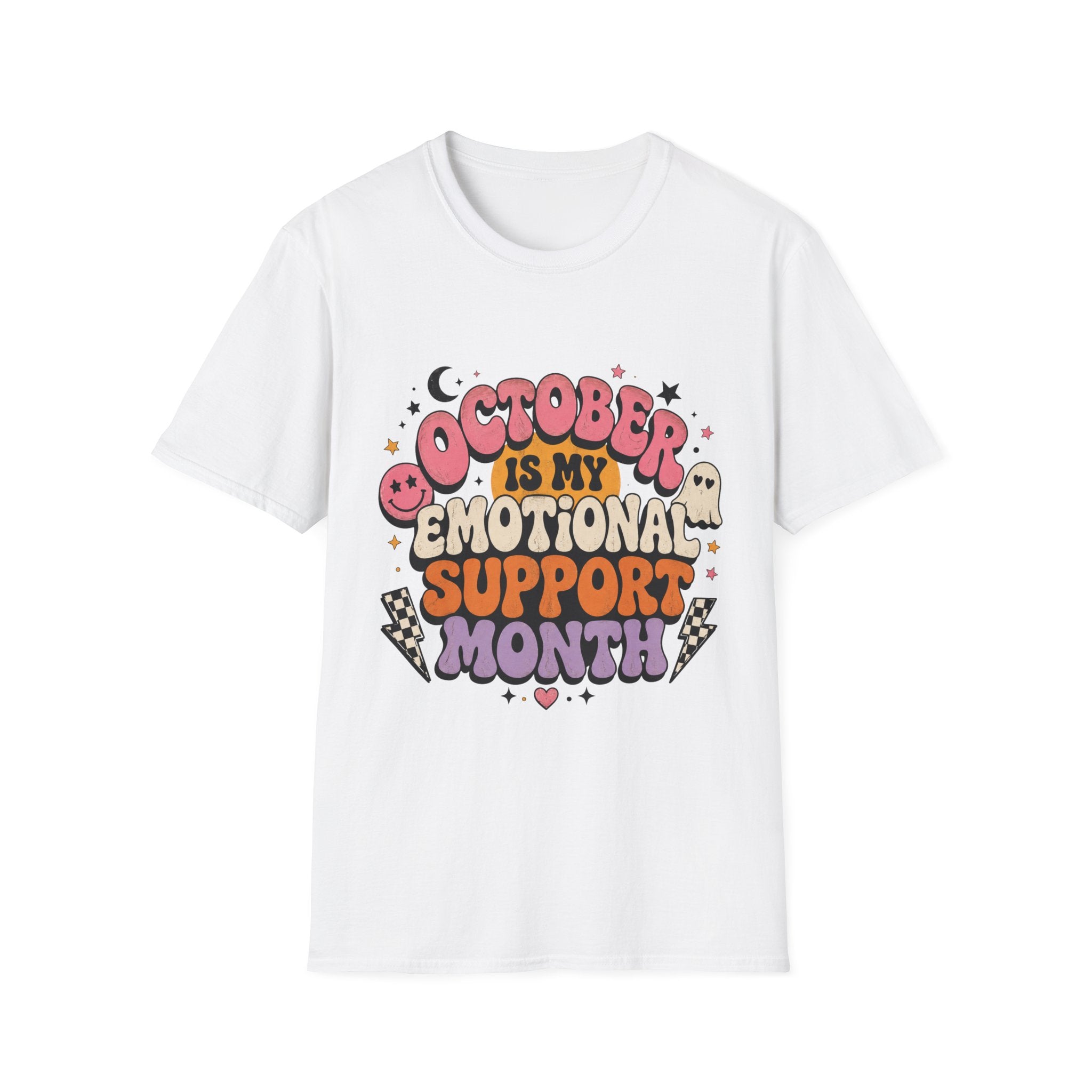 A white short-sleeve crewneck t-shirt featuring a colorful graphic on the front that reads 'OCTOBER IS MY EMOTIONAL SUPPORT MONTH' in playful, Halloween-themed lettering with cute illustrations of a ghost, moon, and stars.