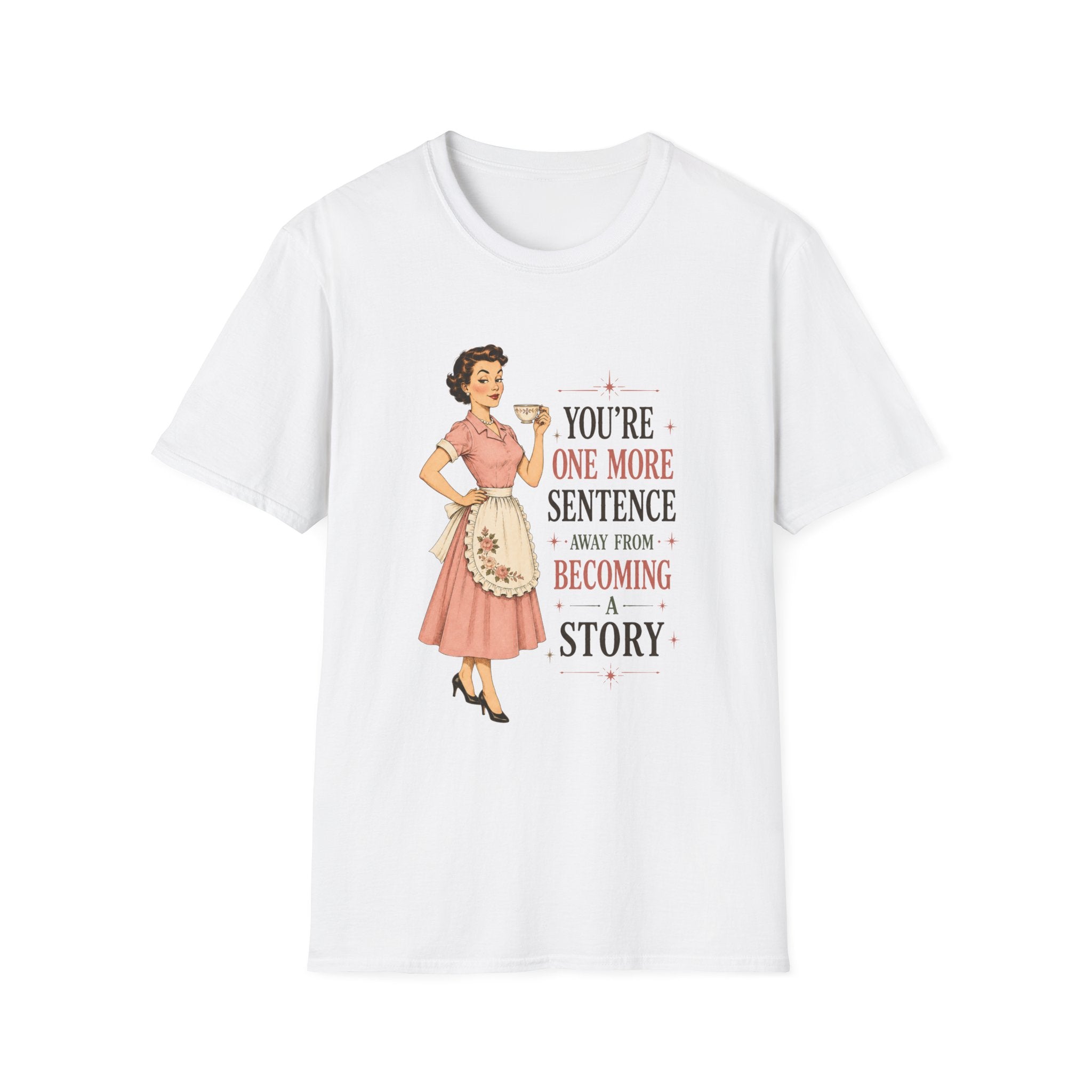 A white short-sleeve crewneck t-shirt featuring a retro-style graphic of a pin-up woman in a pink dress next to the text 'YOU'RE ONE MORE SENTENCE AWAY FROM BECOMING A STORY'.