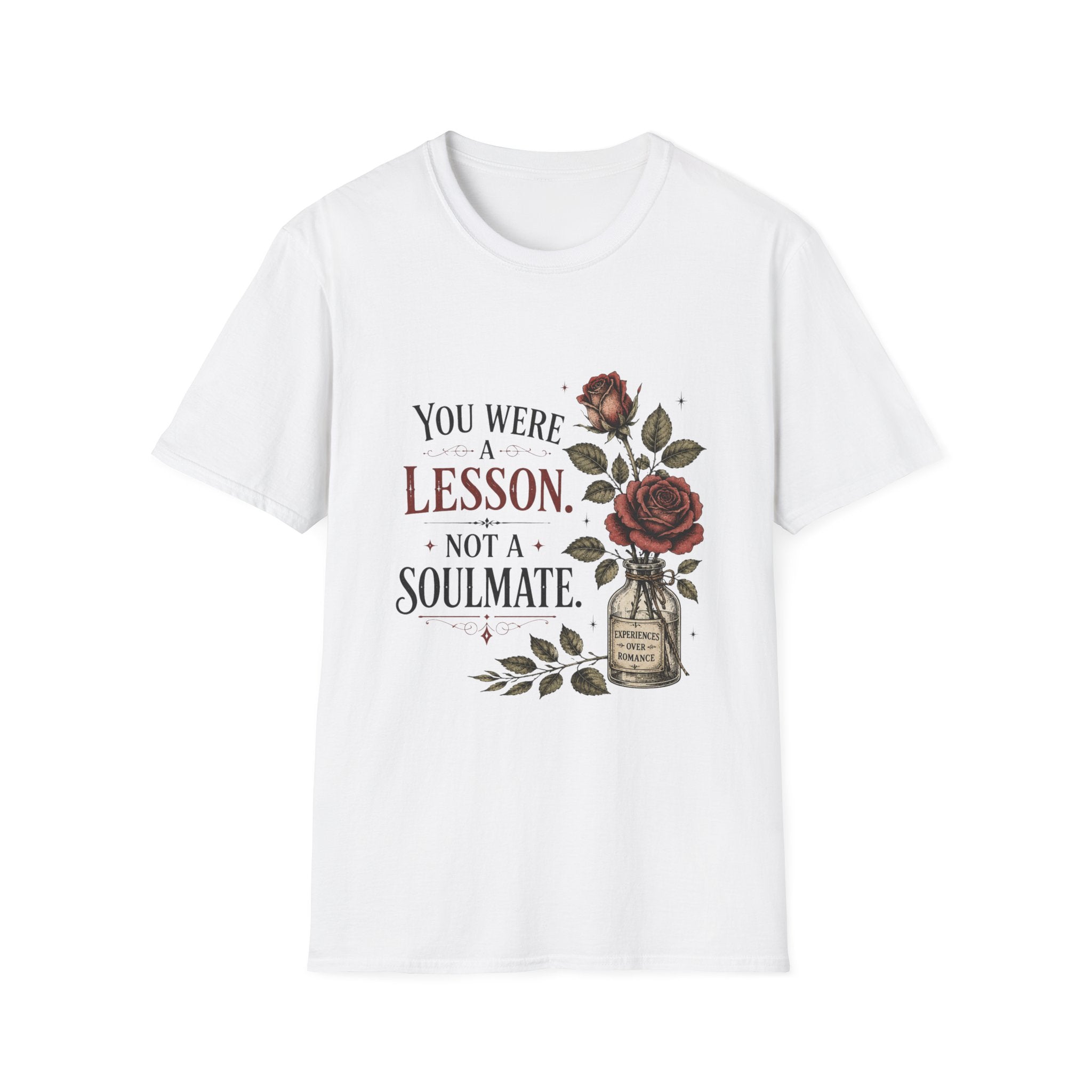 A white short-sleeve crewneck t-shirt featuring a vintage-style graphic print on the front with the text 'YOU WERE A LESSON. NOT A SOULMATE.
