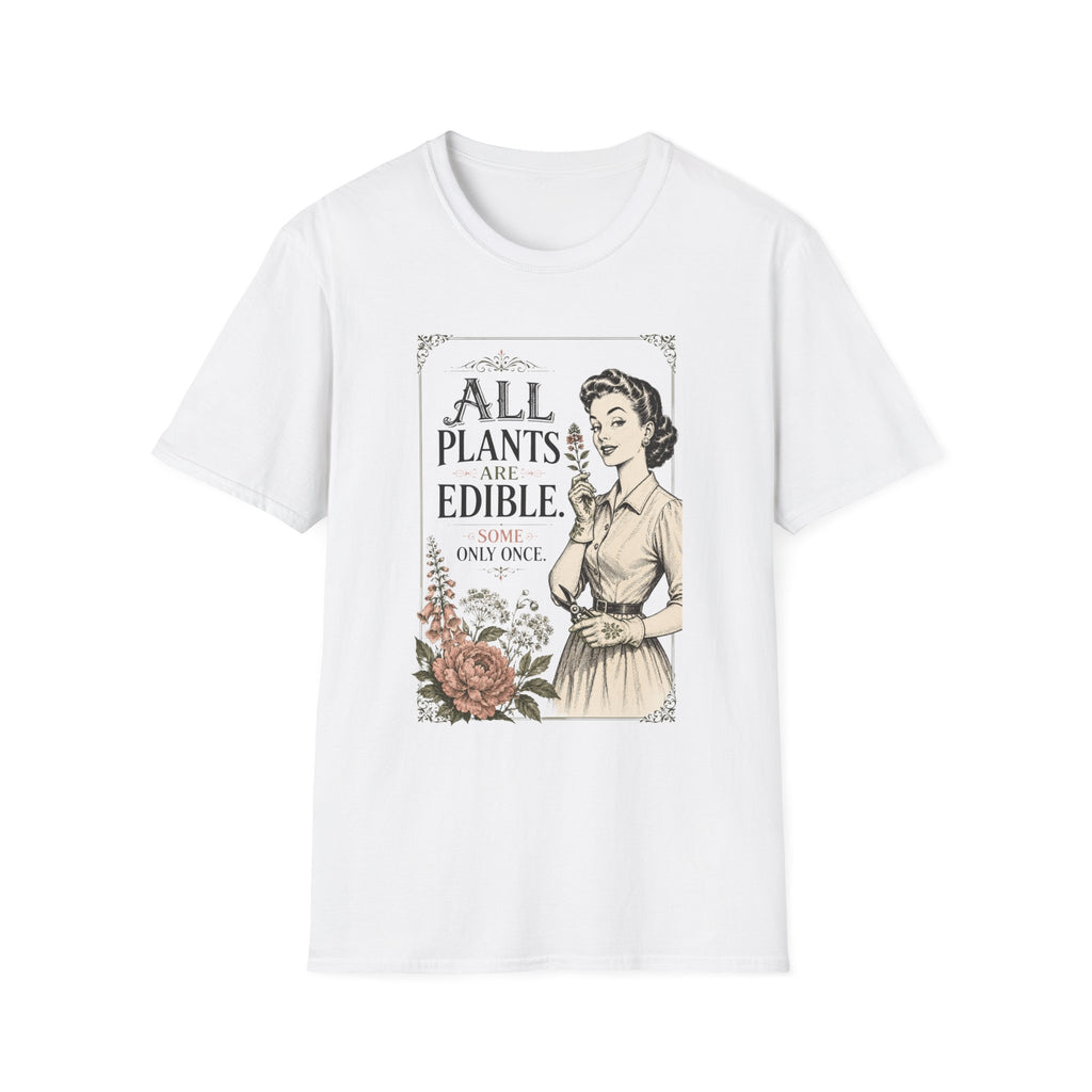 A white short-sleeve crewneck t-shirt featuring a vintage-style graphic print on the front. The print shows a retro illustration of a woman in a dress next to the text 'ALL PLANTS ARE EDIBLE.