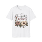 A white short-sleeve crewneck t-shirt featuring a vintage-style graphic on the front with the text 'CLOSURE IS OVERRATED.' in black and muted red lettering, decorated with a pink rose, green leaves, and an antique key over a beige envelope.