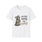 A white short-sleeve crewneck t-shirt featuring a cute cartoon raccoon sitting next to the text 'I'M NOT needy, I'M wanty' in black and brown lettering.
