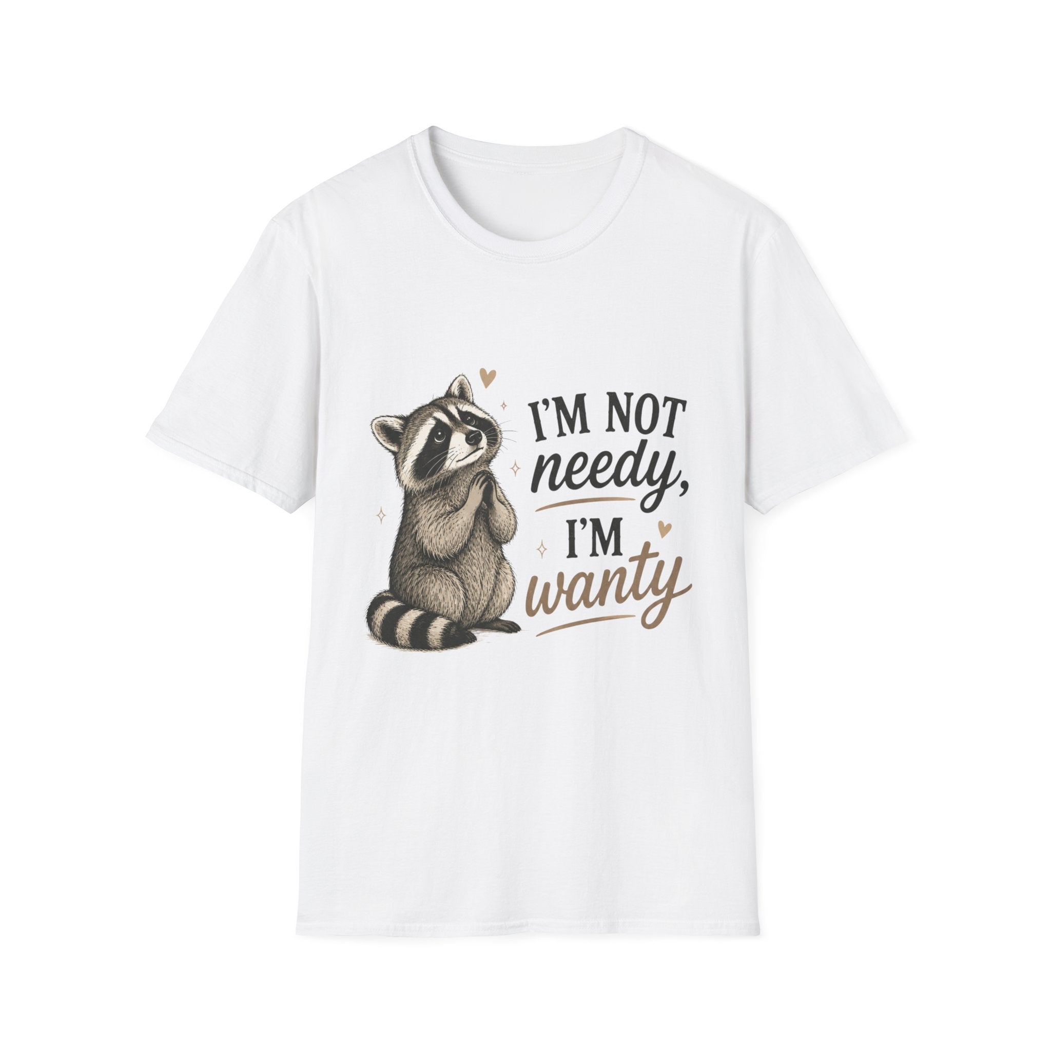 A white short-sleeve crewneck t-shirt featuring a cute cartoon raccoon sitting next to the text 'I'M NOT needy, I'M wanty' in black and brown lettering.