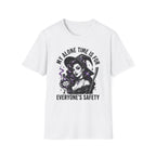 A white short-sleeve crewneck t-shirt featuring a graphic print of a witch with a broom and a potion cup, accompanied by the text 'MY ALONE TIME IS FOR EVERYONE'S SAFETY' in black and purple.