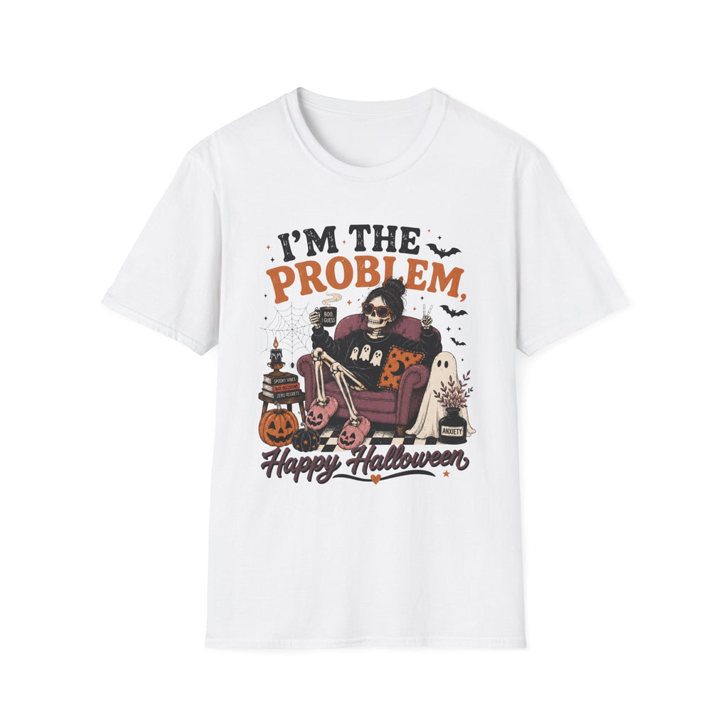 A white short-sleeve crewneck t-shirt featuring a Halloween-themed graphic print on the front. The graphic shows a skeleton sitting in a purple armchair next to a cat, with pumpkins, a cauldron, and the text 'I'M THE PROBLEM' and 'Happy Halloween'.